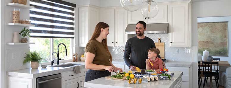Family enjoying time together in the kitchen with new window treatments