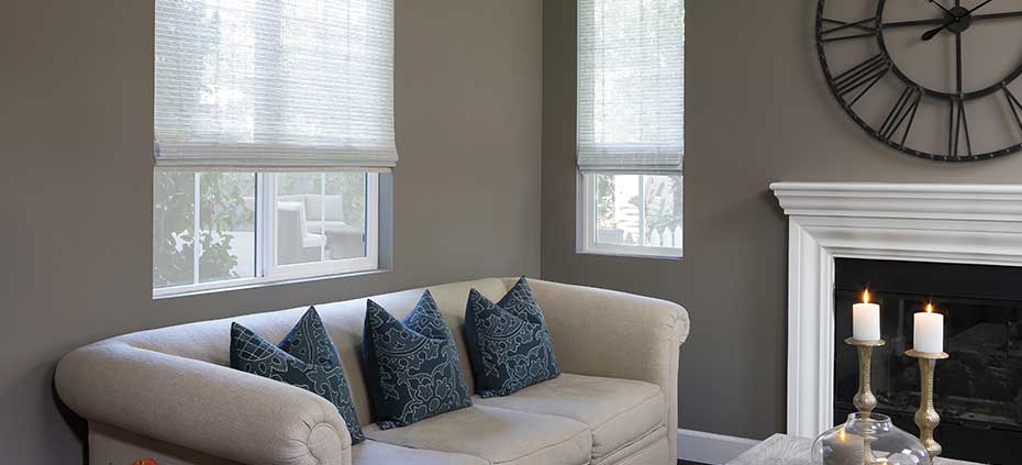 Living room with fire place and custom woven wood shades